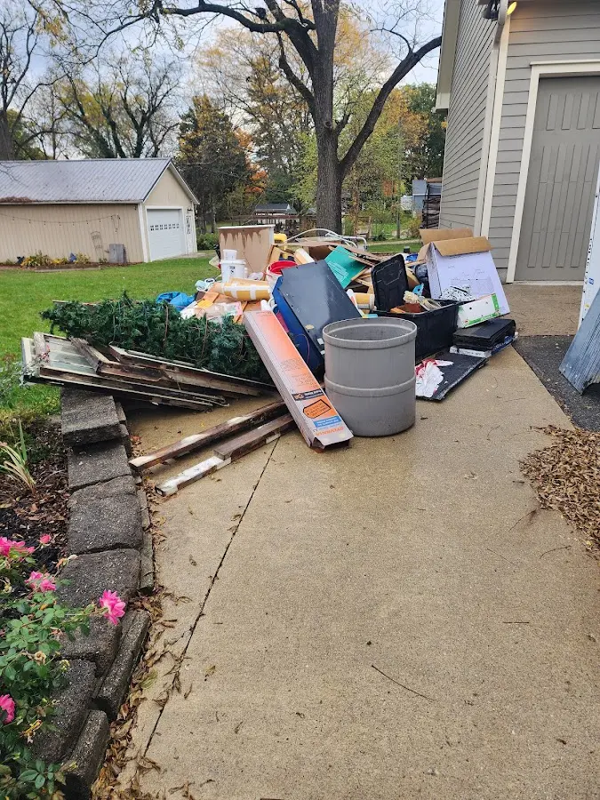 Dumpster being loaded with debris for Roofing Dumpster Rental in Elgin